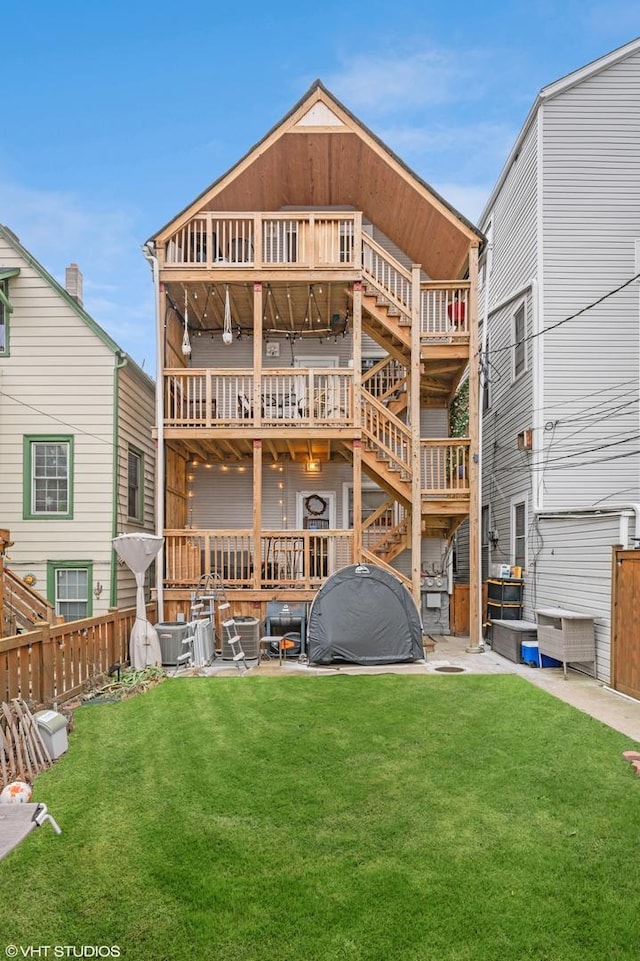 back of property featuring stairs, a yard, a patio, and fence