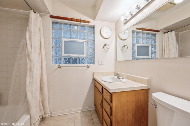 bathroom featuring shower / bath combination with curtain, toilet, vanity, tile patterned flooring, and baseboards