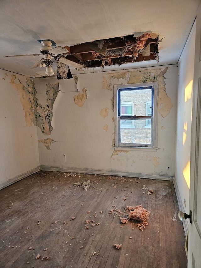 spare room with ceiling fan and wood finished floors