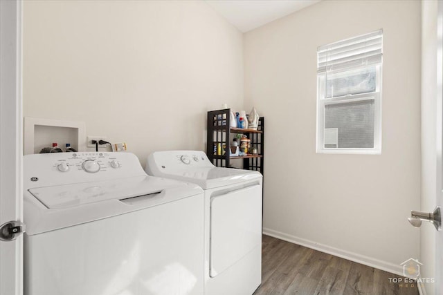 laundry area featuring washer and dryer, baseboards, wood finished floors, and laundry area