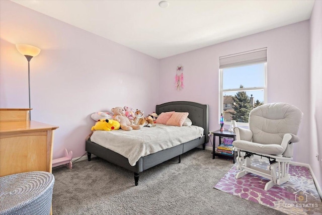 bedroom with baseboards and carpet