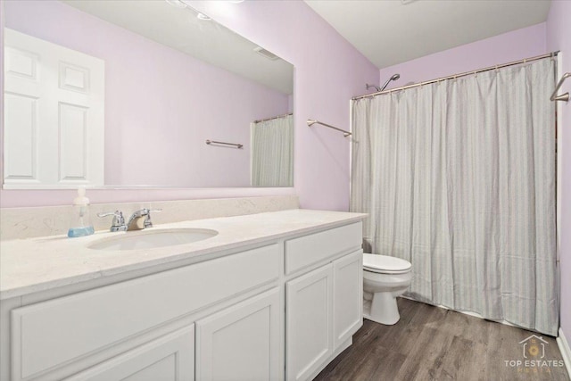 full bath with vanity, a shower with shower curtain, wood finished floors, visible vents, and toilet