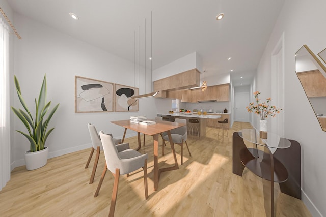 dining room with light wood-type flooring, baseboards, and recessed lighting