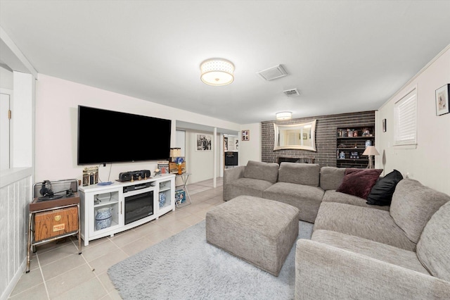 living area featuring light tile patterned floors and visible vents