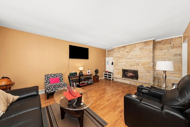 living room with a fireplace, wood finished floors, and baseboards