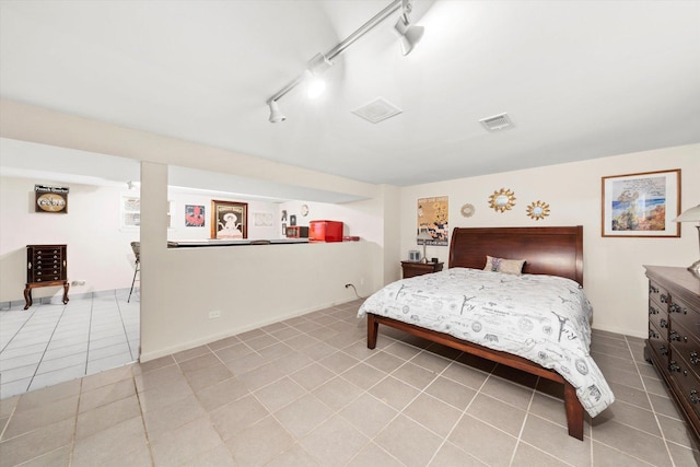 bedroom with light tile patterned floors, visible vents, and track lighting