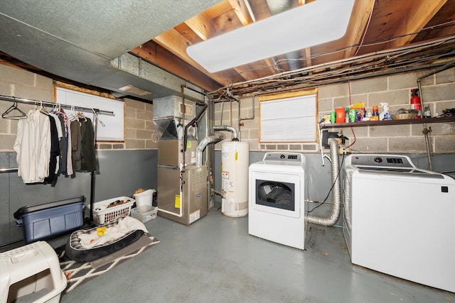 unfinished basement featuring heating unit, water heater, and washer and dryer