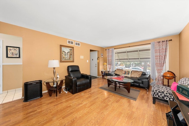 living room with light wood-style flooring and visible vents