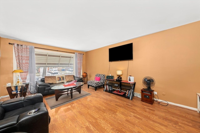 living area with light wood-type flooring and baseboards