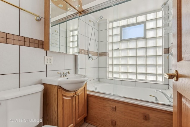 bathroom featuring decorative backsplash, bathing tub / shower combination, toilet, vanity, and tile walls