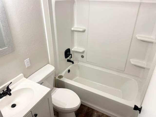 full bath with washtub / shower combination, wood finished floors, vanity, and toilet