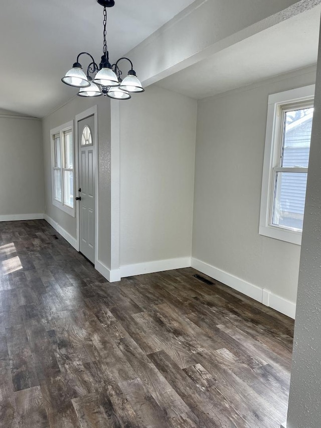 unfurnished dining area featuring dark wood-style flooring, a healthy amount of sunlight, and baseboards