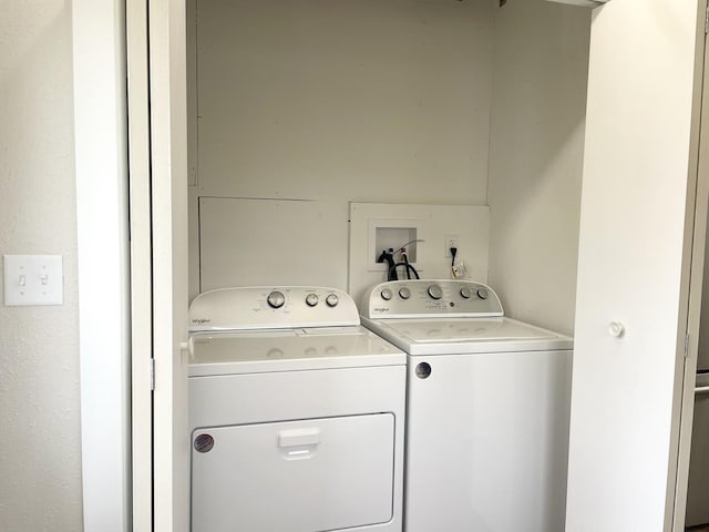 clothes washing area featuring washing machine and dryer and laundry area