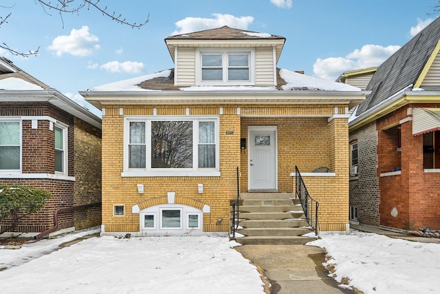 bungalow featuring entry steps and brick siding