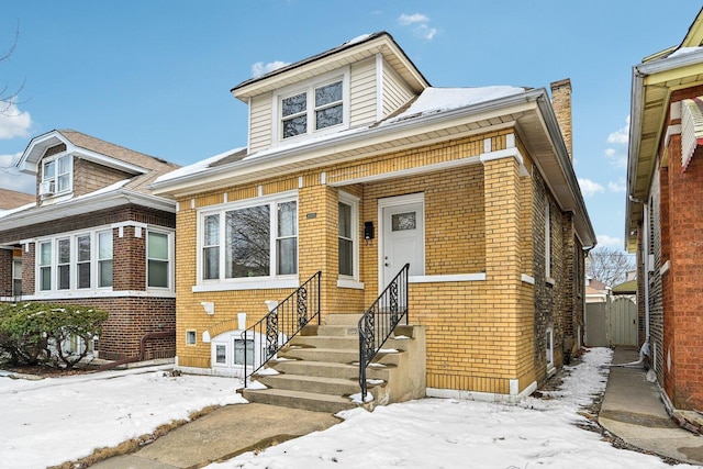 view of front of house with entry steps and brick siding