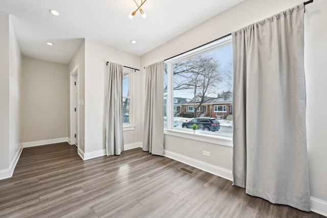 interior space with baseboards, visible vents, wood finished floors, and recessed lighting