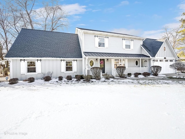 view of front facade featuring a standing seam roof, metal roof, covered porch, a garage, and board and batten siding