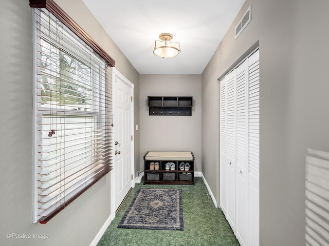 doorway featuring baseboards and visible vents