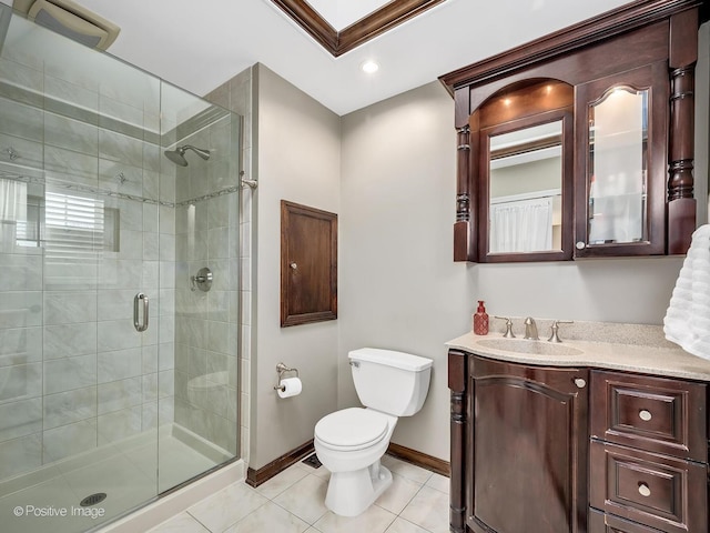 full bath featuring toilet, vanity, baseboards, tile patterned floors, and a stall shower