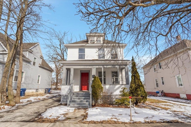 american foursquare style home with a porch