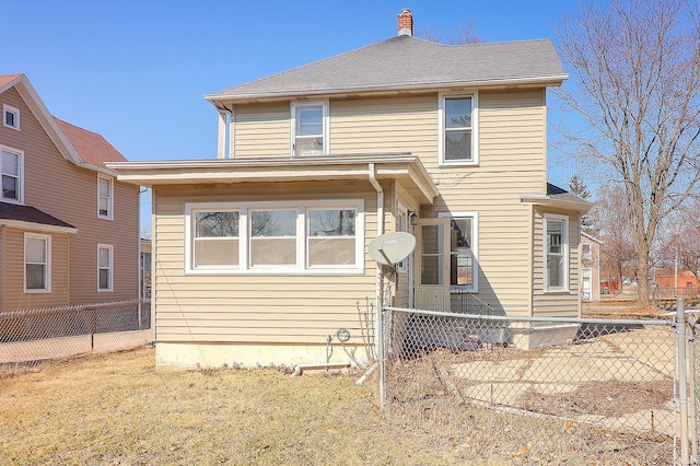 view of front of home with fence private yard and a chimney