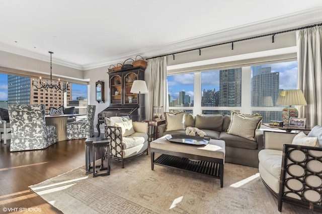 living area featuring a view of city, an inviting chandelier, wood finished floors, and crown molding