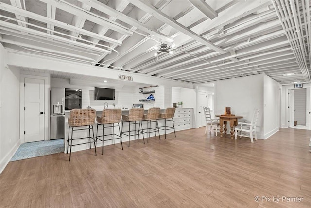 kitchen with a breakfast bar and wood finished floors