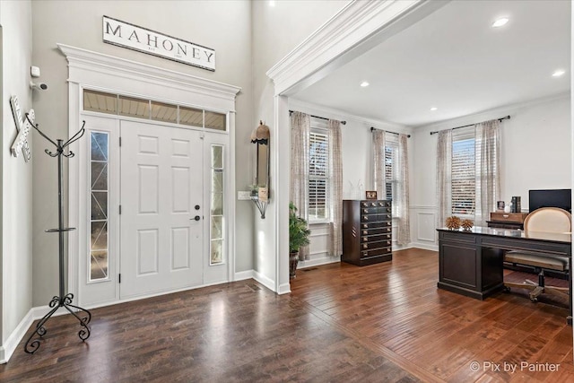 foyer entrance with crown molding, recessed lighting, and dark wood finished floors