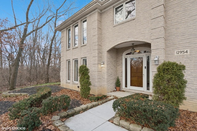 property entrance featuring brick siding