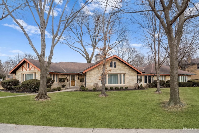 view of front of house with a front yard and stone siding