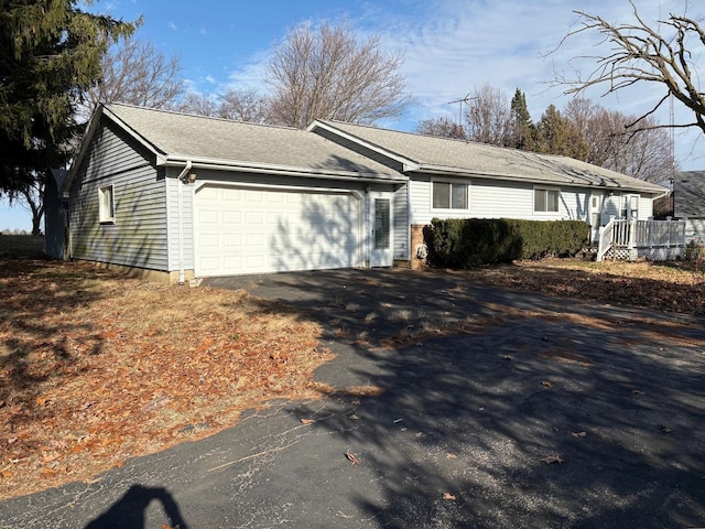 view of property exterior with driveway and an attached garage