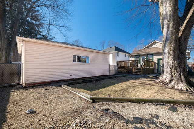 back of house with a wooden deck and fence