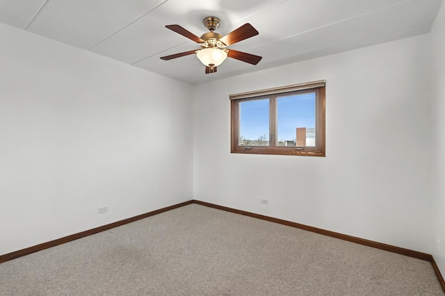 empty room featuring carpet, ceiling fan, and baseboards