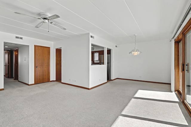 unfurnished room with light carpet, ceiling fan, visible vents, and baseboards