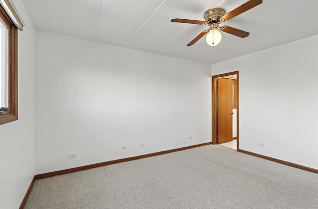 unfurnished room featuring light carpet, ceiling fan, and baseboards