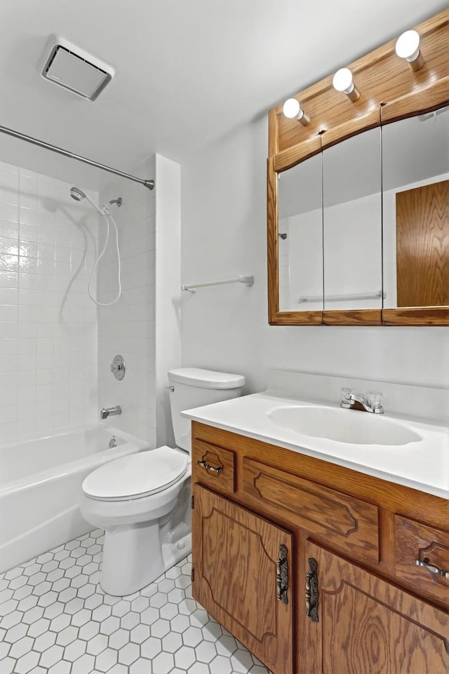 bathroom featuring toilet, bathing tub / shower combination, and vanity