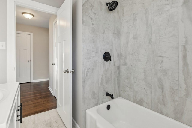 bathroom featuring  shower combination and baseboards