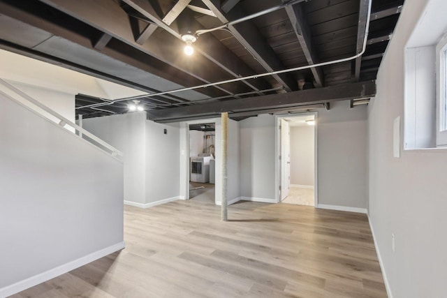 finished below grade area featuring baseboards and wood finished floors