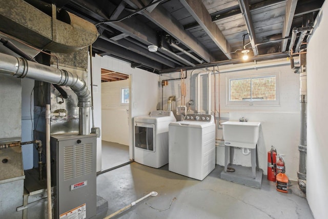 basement with a sink and washing machine and clothes dryer