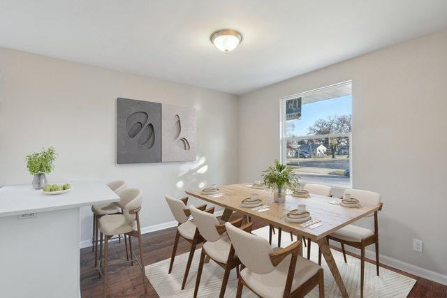 dining room featuring wood finished floors and baseboards