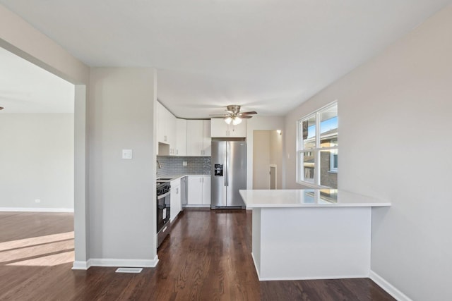 kitchen featuring white cabinetry, light countertops, black range oven, stainless steel fridge with ice dispenser, and tasteful backsplash