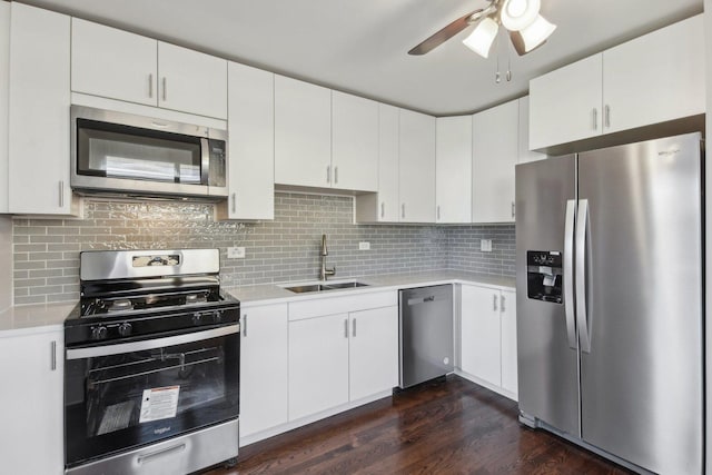 kitchen featuring light countertops, appliances with stainless steel finishes, a sink, and white cabinets