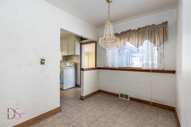 unfurnished dining area featuring baseboards, visible vents, and a chandelier