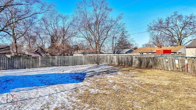 snow covered pool featuring a fenced backyard