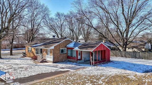 exterior space with entry steps, brick siding, and fence