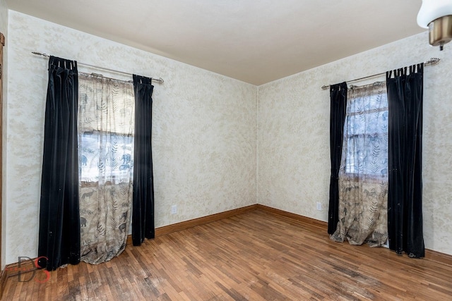 spare room with wood finished floors