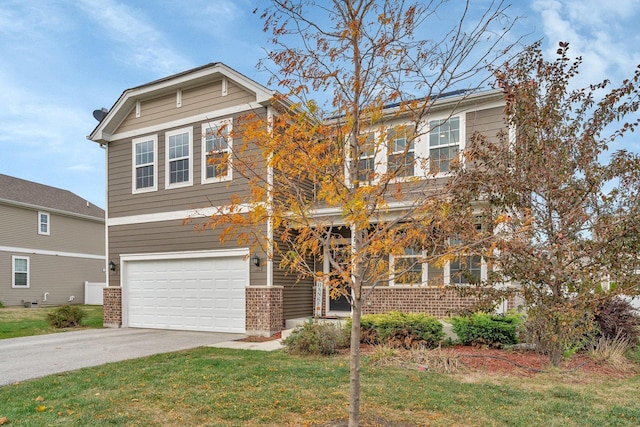 view of front of home with a garage, a front yard, concrete driveway, and brick siding