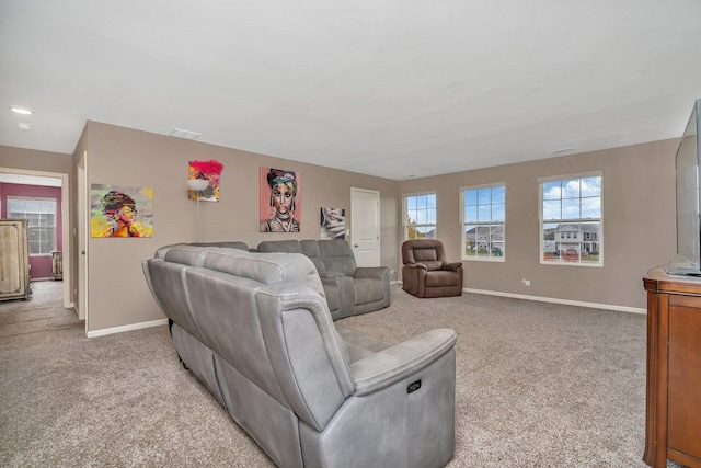 living area featuring light carpet, visible vents, and baseboards