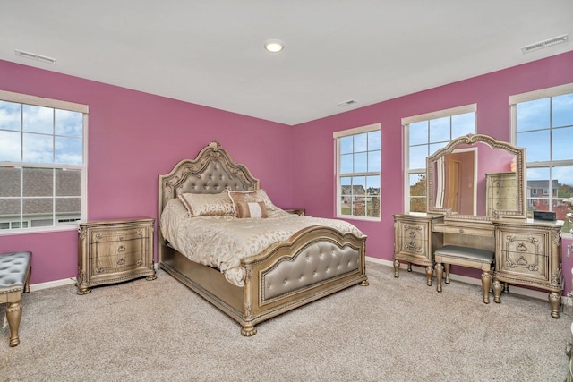 bedroom featuring multiple windows, visible vents, and baseboards