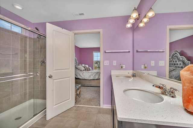 ensuite bathroom with visible vents, connected bathroom, and a sink